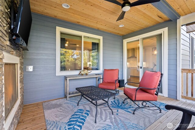 wooden terrace featuring a ceiling fan