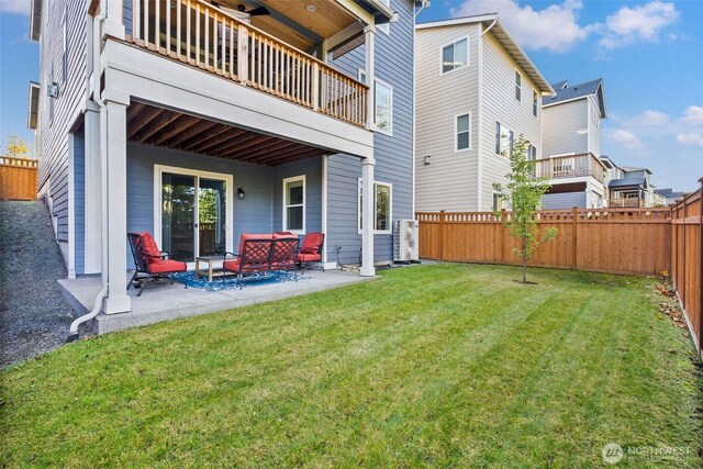 rear view of house with a patio, a balcony, a yard, and a fenced backyard