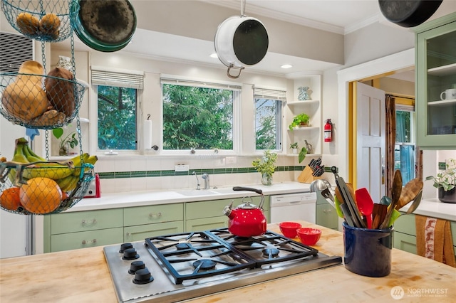 kitchen with dishwasher, light countertops, ornamental molding, stainless steel gas stovetop, and green cabinetry