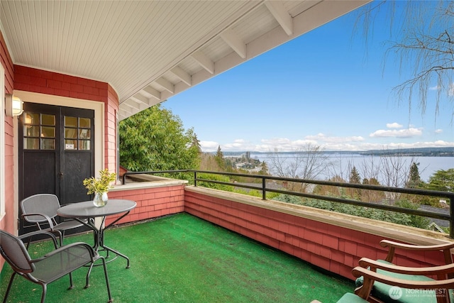 balcony with a sunroom and a water view