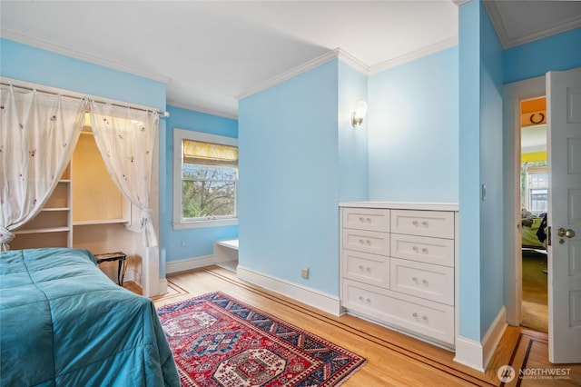 bedroom featuring baseboards, light wood-type flooring, and ornamental molding