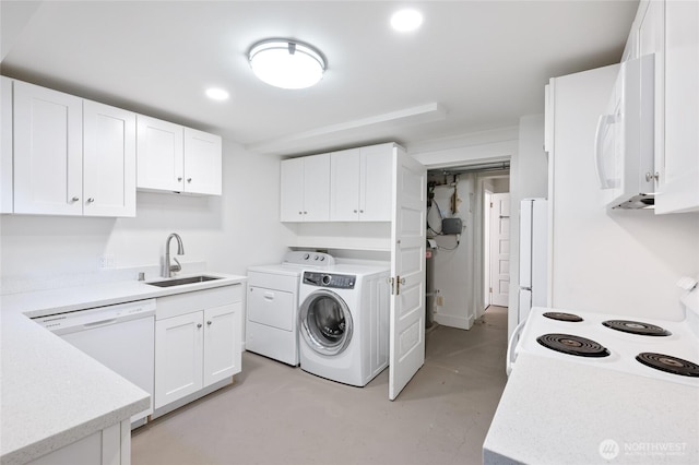 clothes washing area featuring a sink, recessed lighting, laundry area, and washer and clothes dryer