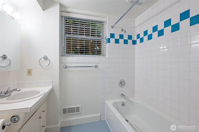 full bath with visible vents, vanity, shower / tub combination, and baseboards