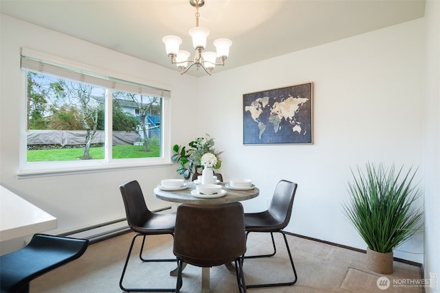 carpeted dining space with a chandelier and baseboard heating