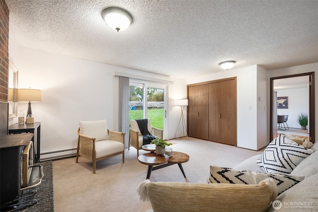 living room featuring a baseboard heating unit, a wood stove, light colored carpet, and a textured ceiling