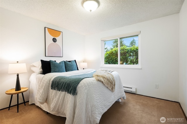 carpeted bedroom featuring baseboard heating and a textured ceiling