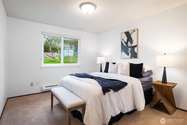 bedroom featuring a baseboard heating unit, carpet flooring, and a textured ceiling