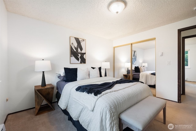 bedroom with a closet, carpet floors, and a textured ceiling