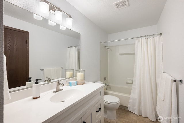 bathroom with visible vents, toilet, vanity, a textured ceiling, and shower / bathtub combination with curtain