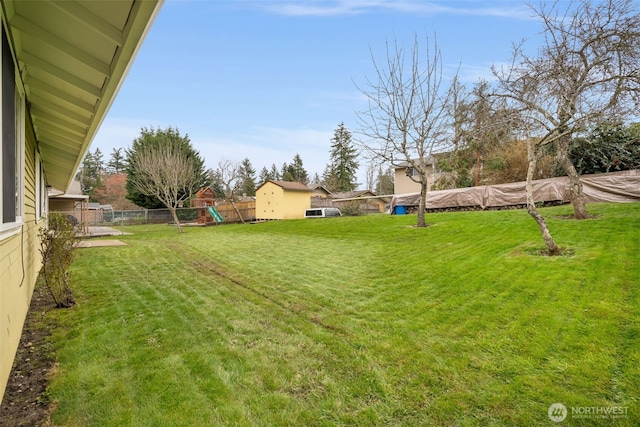 view of yard with a playground and a fenced backyard