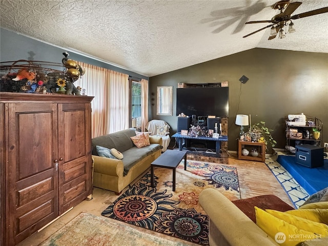 living room with a textured ceiling, lofted ceiling, and ceiling fan