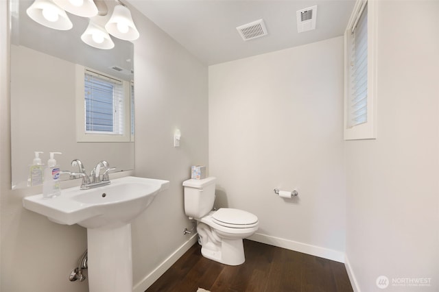 bathroom featuring visible vents, toilet, baseboards, and wood finished floors