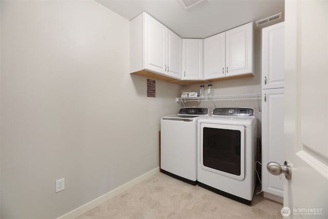 laundry room featuring baseboards, cabinet space, visible vents, and washing machine and clothes dryer