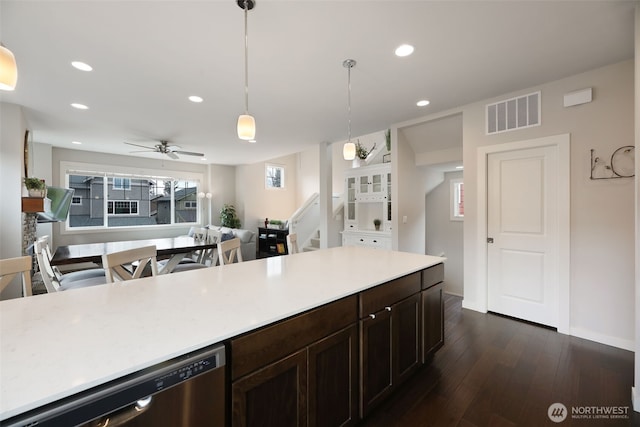 kitchen with visible vents, dark wood finished floors, recessed lighting, light countertops, and stainless steel dishwasher