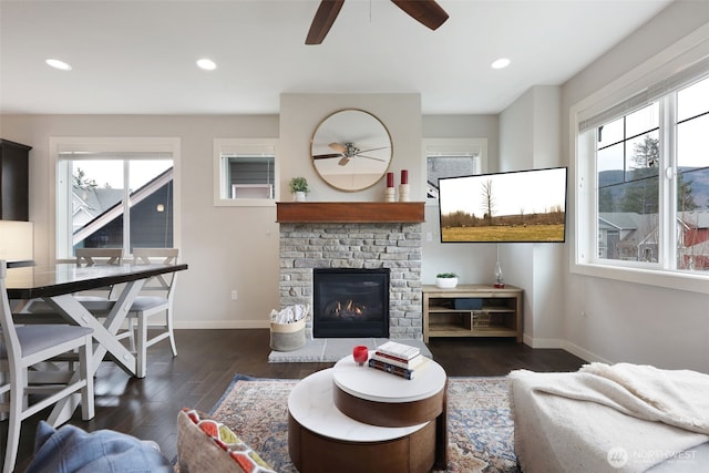 living room featuring baseboards, plenty of natural light, and wood finished floors