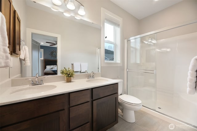 full bath with tile patterned floors, a shower stall, connected bathroom, and a sink