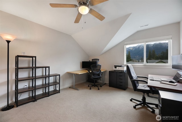 carpeted home office featuring visible vents, ceiling fan, baseboards, and lofted ceiling