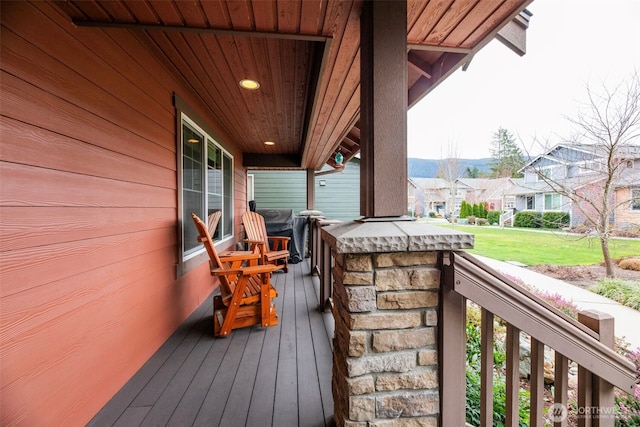 deck with a residential view and a porch