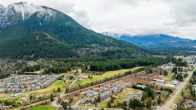 aerial view featuring a forest view and a mountain view