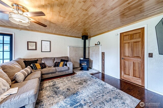 living area featuring wood finished floors, wood ceiling, and ornamental molding