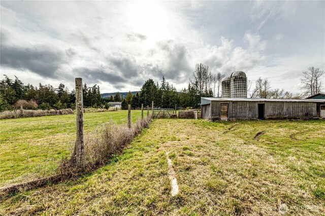 view of yard with an outdoor structure and fence