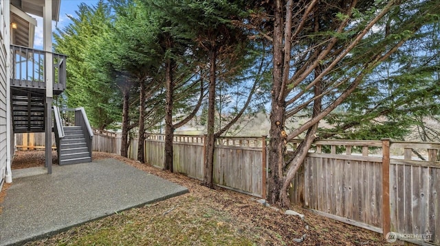 view of yard featuring stairway and a fenced backyard