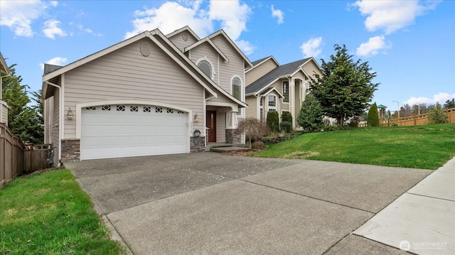 view of front of house featuring a front yard, fence, concrete driveway, a garage, and stone siding