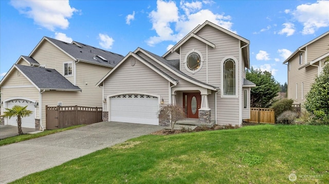 view of front of property featuring a front lawn, an attached garage, fence, and driveway