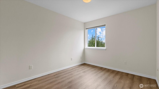 empty room featuring light wood-style flooring and baseboards