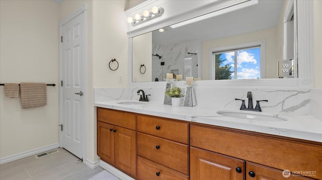 bathroom featuring a sink, visible vents, a shower, and double vanity