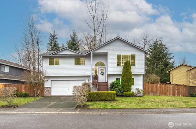 bi-level home featuring a front yard, an attached garage, fence, and driveway