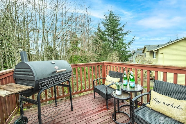 wooden terrace with a grill