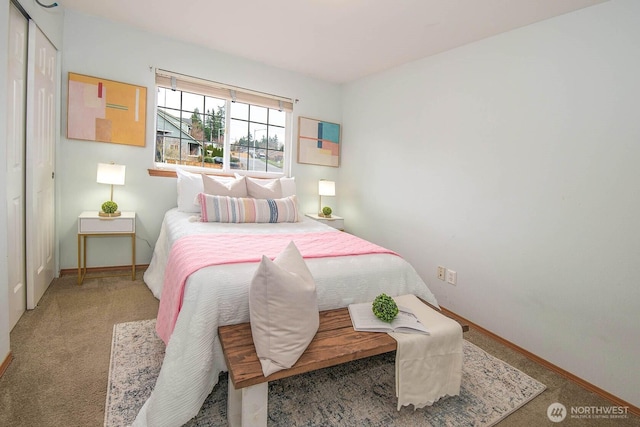 carpeted bedroom with baseboards and a closet