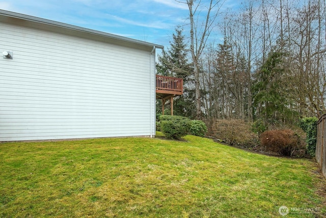 view of property exterior with a lawn and a wooden deck