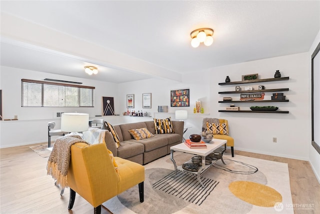 living room featuring light wood-type flooring and baseboards