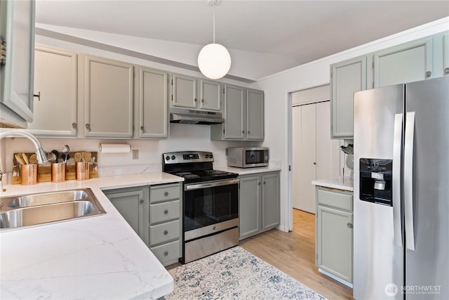 kitchen featuring under cabinet range hood, gray cabinetry, stainless steel appliances, and a sink