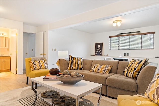 living room with visible vents and light wood finished floors