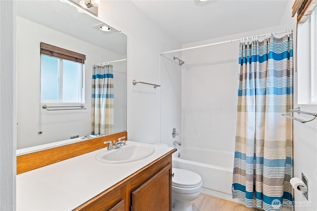 bathroom featuring shower / bath combo with shower curtain, toilet, and vanity