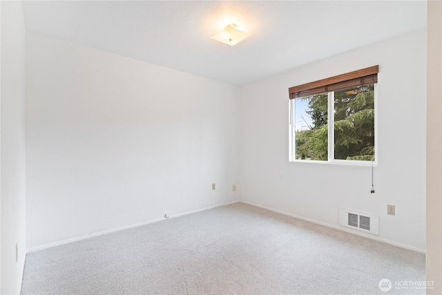 unfurnished room with baseboards, visible vents, and light carpet