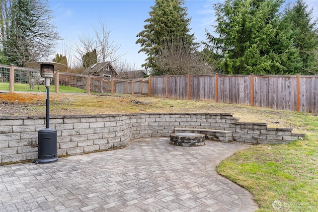 view of patio with an outdoor fire pit and a fenced backyard