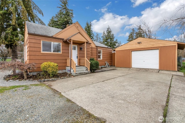 view of front of house with a garage, driveway, an outdoor structure, and roof with shingles