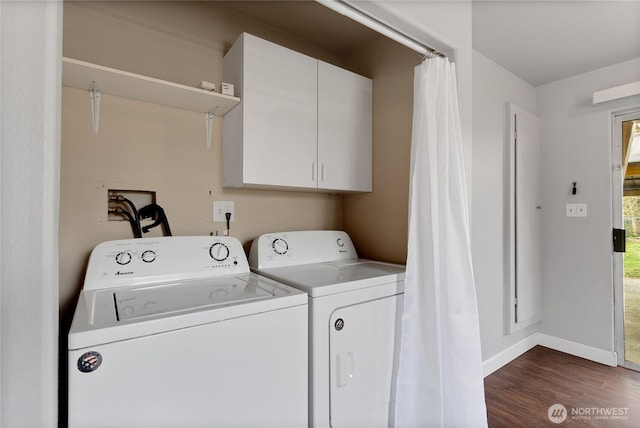 clothes washing area with cabinet space, baseboards, dark wood finished floors, and washer and clothes dryer