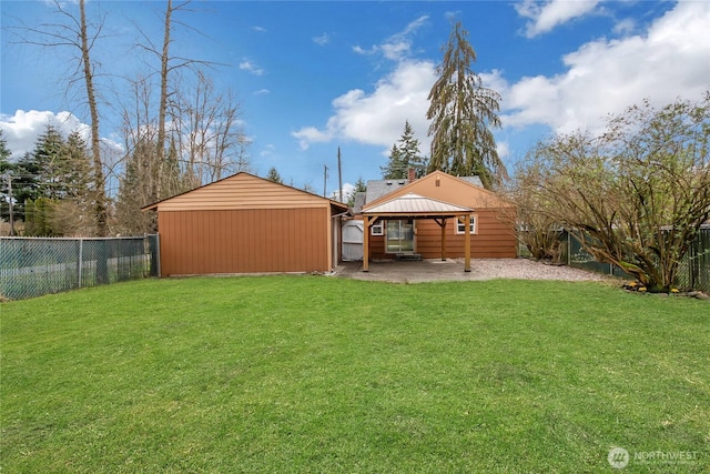 view of yard featuring a patio area, a gazebo, an outbuilding, and a fenced backyard