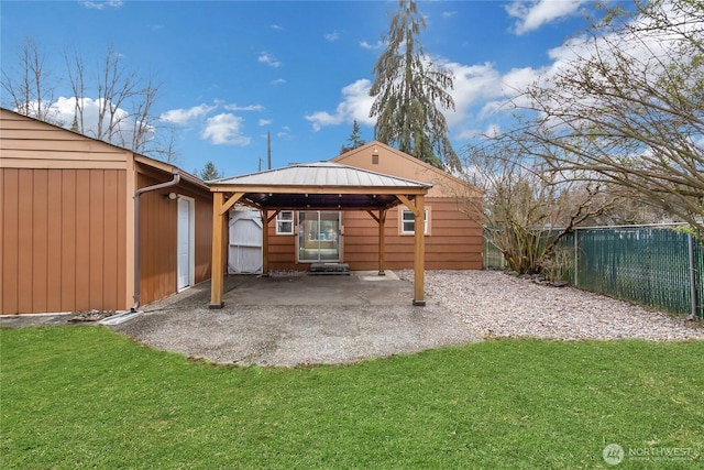 back of property with a gazebo, a lawn, fence, and a patio