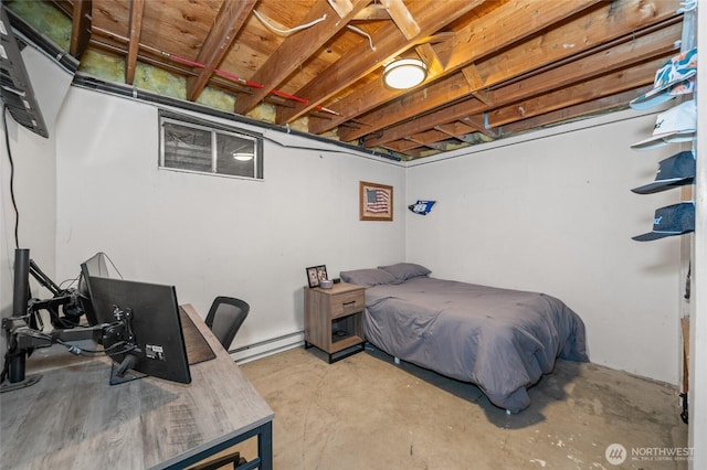 bedroom with a baseboard radiator and unfinished concrete flooring