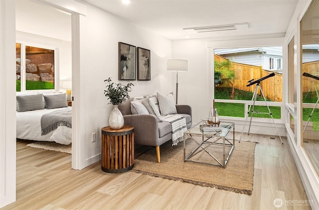 living room featuring recessed lighting, visible vents, and wood finished floors