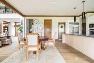 dining room featuring wood finished floors and crown molding