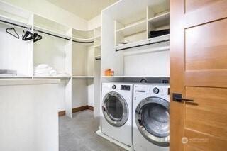 clothes washing area featuring washer and dryer and laundry area