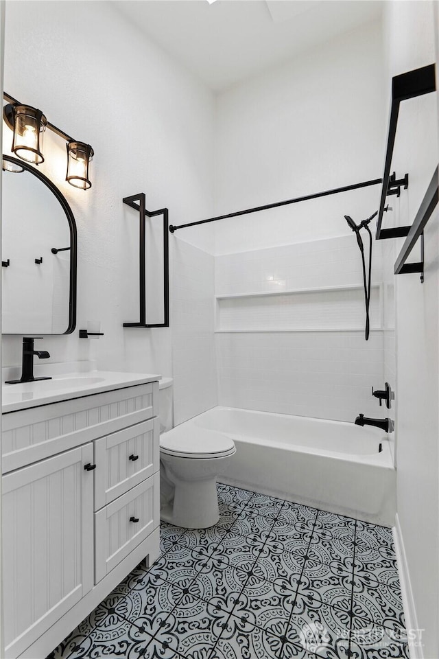 full bathroom with tile patterned flooring, baseboards, toilet, bathing tub / shower combination, and vanity