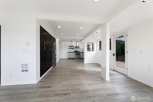 hallway with recessed lighting, visible vents, baseboards, and light wood-style floors